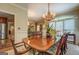 Dining room with hardwood floors, elegant chandelier, and large table with seating at 95 Weslyan Way, Oxford, GA 30054