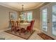 Elegant dining room with stylish chandelier, seating for six, and access to the patio at 95 Weslyan Way, Oxford, GA 30054