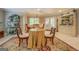 Cozy dining room features a round table, elegant chairs, and bright natural light at 95 Weslyan Way, Oxford, GA 30054