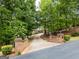 Long, winding driveway leading to a beautiful home through a lush, green wooded area at 95 Weslyan Way, Oxford, GA 30054