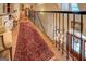 An ornate carpeted staircase in the foyer is visible from the second floor landing at 95 Weslyan Way, Oxford, GA 30054