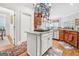 Kitchen featuring an island with a cooktop, stainless steel appliances, and ample cabinet space at 95 Weslyan Way, Oxford, GA 30054