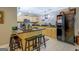 Kitchen with island, bar seating, light hardwood cabinets, and black appliances at 95 Weslyan Way, Oxford, GA 30054