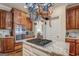 Kitchen island with a cooktop and hanging pot rack, plus stainless steel appliances at 95 Weslyan Way, Oxford, GA 30054