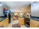Open kitchen features tiled floors, wooden cabinets, and granite countertops at 95 Weslyan Way, Oxford, GA 30054
