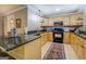 Well-lit kitchen features wooden cabinets, stainless steel appliances, and beautiful countertops at 95 Weslyan Way, Oxford, GA 30054