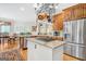 Kitchen with stainless steel appliances, a large island, and hardwood floors at 95 Weslyan Way, Oxford, GA 30054