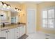 Bright bathroom features a double vanity with granite countertops and shuttered windows at 5 Renfroe Ct, Decatur, GA 30030