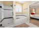 Bright bathroom features a glass-enclosed shower, soaking tub, and access to main bedroom at 5 Renfroe Ct, Decatur, GA 30030