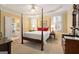 Bedroom with tray ceiling, carpet floors, and ensuite bathroom access at 5 Renfroe Ct, Decatur, GA 30030