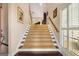 A carpeted staircase with wooden handrail leads to the upper level at 5 Renfroe Ct, Decatur, GA 30030