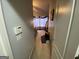 Long hallway featuring closet and bedroom access at 1255 Chinon Pt, Lithonia, GA 30058