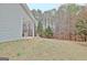 Side view of back yard, patio and tree line at 131 Meadowbrook Ln, Grantville, GA 30220