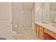 Well-lit bathroom featuring a walk-in shower, a spacious vanity, and neutral tile flooring at 131 Meadowbrook Ln, Grantville, GA 30220