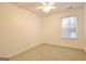 Bright bedroom with neutral carpet, ceiling fan, and window at 131 Meadowbrook Ln, Grantville, GA 30220