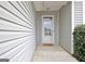 Inviting entryway with a glass-paneled front door, light gray siding, and a welcoming doormat at 131 Meadowbrook Ln, Grantville, GA 30220