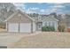 Charming single-Gathering home featuring a two-car garage and stone accents with manicured landscaping at 131 Meadowbrook Ln, Grantville, GA 30220