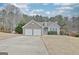 Lovely home featuring a two-car garage, stone facade, and well-kept landscaping, creating a welcoming curb appeal at 131 Meadowbrook Ln, Grantville, GA 30220