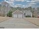 Charming home with stone accents, a two-car garage, and a well-maintained front yard on a sunny day at 131 Meadowbrook Ln, Grantville, GA 30220