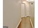 Hallway with wood floors featuring two doors at 131 Meadowbrook Ln, Grantville, GA 30220