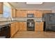 Fully equipped kitchen featuring wood cabinets, black appliances, and ample counter space at 131 Meadowbrook Ln, Grantville, GA 30220