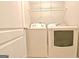 Well-equipped laundry area features appliances and storage shelving for convenience at 131 Meadowbrook Ln, Grantville, GA 30220