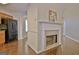 Stylish living space featuring a fireplace and a view of the kitchen with modern appliances at 131 Meadowbrook Ln, Grantville, GA 30220