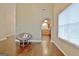 Open floor plan showcasing hardwood floors, a cozy chair, and a view into the kitchen at 131 Meadowbrook Ln, Grantville, GA 30220