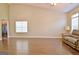 Spacious living area featuring sleek hardwood floors, high ceilings, and great natural light from large windows at 131 Meadowbrook Ln, Grantville, GA 30220