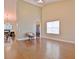Open living space with hardwood flooring, high ceilings, a modern chair, and views to the kitchen and dining area at 131 Meadowbrook Ln, Grantville, GA 30220