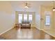 Bright living room featuring hardwood floors, a comfortable couch, and natural light from three large windows at 131 Meadowbrook Ln, Grantville, GA 30220