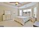 Spacious main bedroom with a tray ceiling, ceiling fan, and ensuite bath at 131 Meadowbrook Ln, Grantville, GA 30220