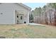 View of back yard patio, seating, and trees at 131 Meadowbrook Ln, Grantville, GA 30220