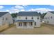 Rear elevation of home showing backyard with covered porch and brick base columns at 1817 Quaker St, Hampton, GA 30228