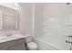 Bathroom featuring a single vanity with framed mirror and bathtub with shower and bright lighting at 1817 Quaker St, Hampton, GA 30228