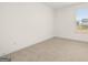 Bright bedroom features neutral carpet, base trim, and natural light at 1817 Quaker St, Hampton, GA 30228