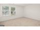 Bedroom features neutral carpet, base trim, and natural light at 1817 Quaker St, Hampton, GA 30228