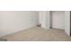 Bedroom boasts neutral carpet, base trim, walk-in closet, and natural light at 1817 Quaker St, Hampton, GA 30228