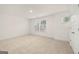 Bright bedroom features neutral carpet, base trim, and natural light at 1817 Quaker St, Hampton, GA 30228