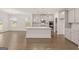 Spacious kitchen with granite countertops, stainless steel appliances, a large island, and an open floor plan at 1817 Quaker St, Hampton, GA 30228