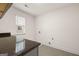 Laundry room featuring granite countertop and window with natural light, and tile floors at 1817 Quaker St, Hampton, GA 30228