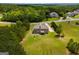 Aerial view of a home situated on a large lot surrounded by lush greenery in a serene neighborhood at 127 Grayson Myers Dr, Villa Rica, GA 30180