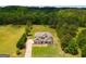 Stunning aerial view showcasing a home with lush landscaping, long driveway, and ample backyard space at 127 Grayson Myers Dr, Villa Rica, GA 30180