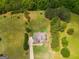 Aerial view of a luxurious property with a well-manicured lawn surrounded by mature trees and landscaping at 127 Grayson Myers Dr, Villa Rica, GA 30180