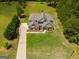 Aerial view of a sprawling home with lush landscaping, long driveway, and ample space for outdoor activities at 127 Grayson Myers Dr, Villa Rica, GA 30180