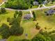 Aerial view of a spacious property featuring mature trees, a trampoline, and a well-manicured lawn at 127 Grayson Myers Dr, Villa Rica, GA 30180