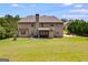 The large backyard features lush green grass, mature trees and a beautiful house at 127 Grayson Myers Dr, Villa Rica, GA 30180