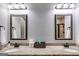 Bathroom featuring double sinks with granite countertops, framed mirrors, and ample lighting at 127 Grayson Myers Dr, Villa Rica, GA 30180