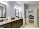 Well-lit bathroom features double sinks, granite countertops, and neutral decor for a clean and modern feel at 127 Grayson Myers Dr, Villa Rica, GA 30180
