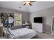 Bright bedroom with a desk, dresser, TV, and a comfy white bed at 127 Grayson Myers Dr, Villa Rica, GA 30180